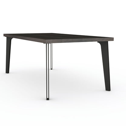 Rustic black oak dining table by Wildwuchs-Möbel with solid steel "hollow leg" base, showcasing natural wood grain.